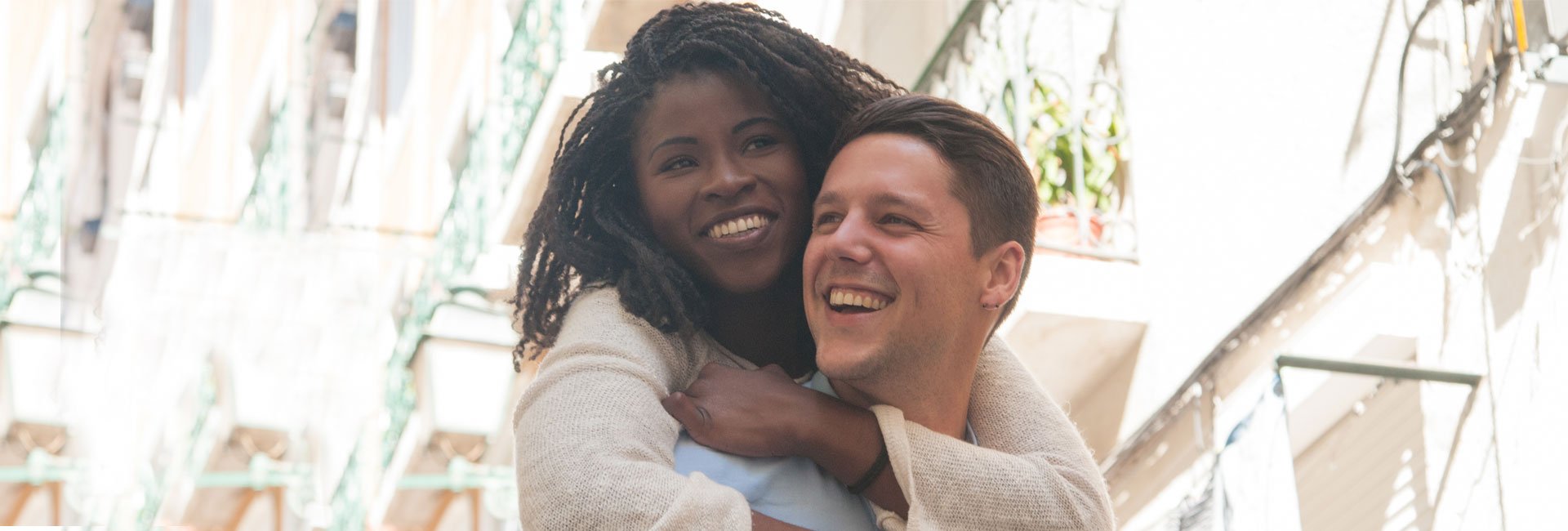 Wife-wrapping-her-husband-up-in-hug-after-opening-a-home-equity-loan-and-feeling-financially-free